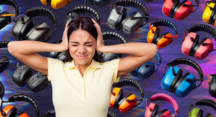 A woman covering her ears with a pained expression, surrounded by various over-the-ear ear muffs in different colors and styles, highlighting the need for effective hearing protection.